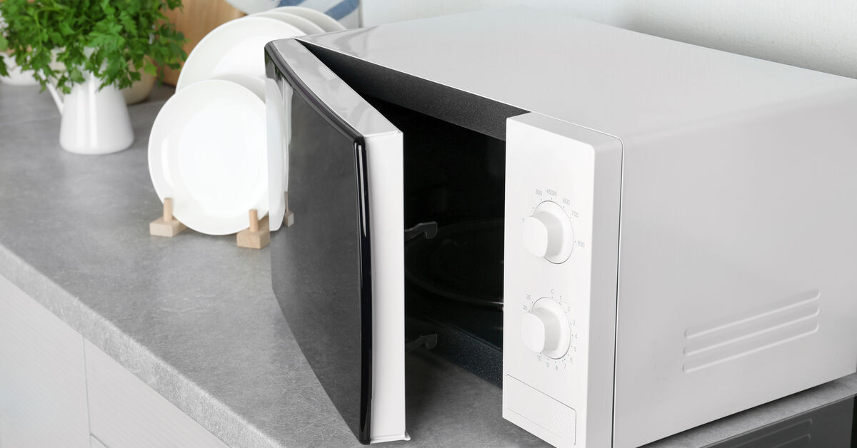 Open microwave ready for careful cleaning