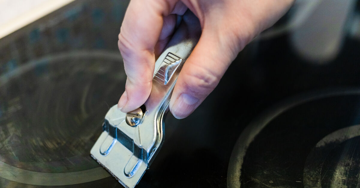 Cooktop scraper for burned residue removal