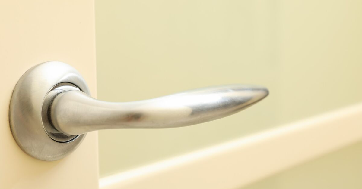 Fingerprints on white door handle